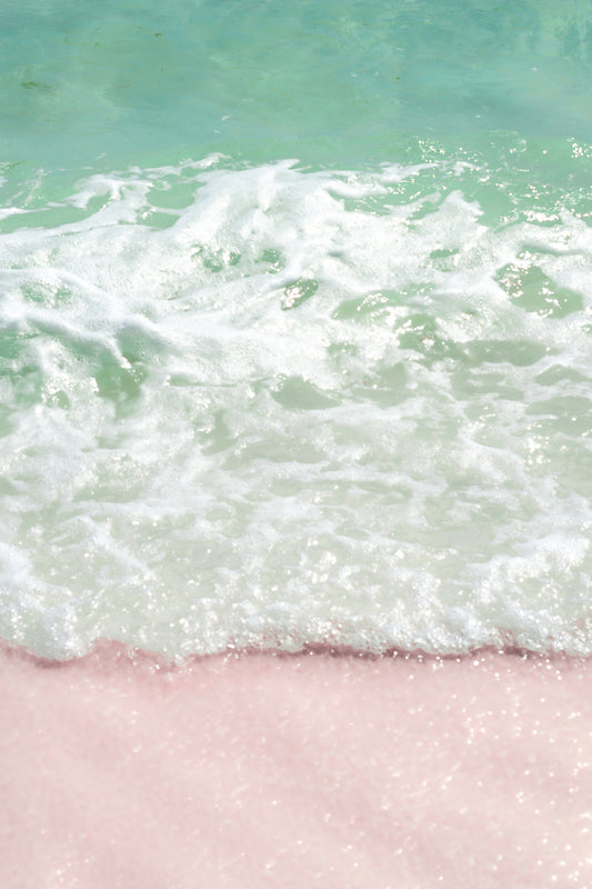 Fine art photography print featuring teal waters crashing upon pink sand beach. The composition is divided in three, mimicking Neapolitan ice cream. The top is teal from the ocean's waters. The middle portion is white from the salt spray of incoming waves. The bottom portion is pink from the pink-sand beach.